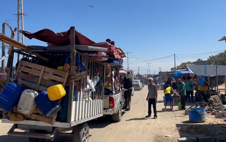 A photo of vehicles (trucks, small cars, bicycles, and animal-drawn carts) loaded with items as Palestinians flee Rafah.